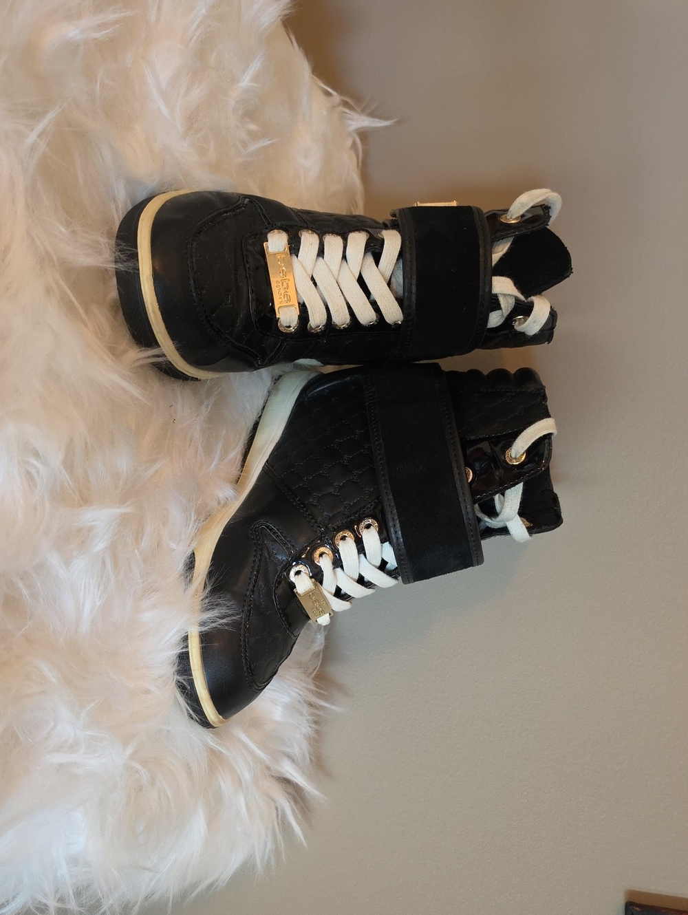 bebe Black and White Quilted Wedge Sneakers with Gold Accents